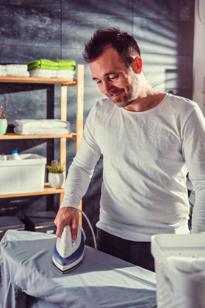 istock Men ironing clothes at home 942030046