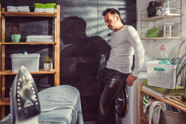 istock Man waiting for laundry at home 942030210