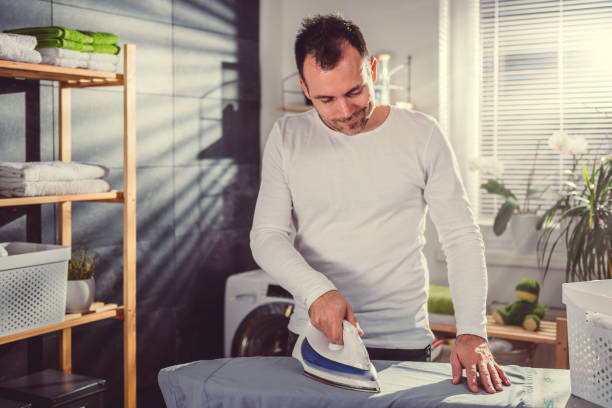 istock Men ironing clothes at home 942030254