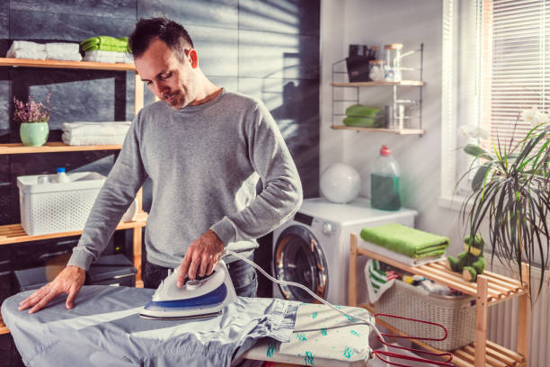 istock Men ironing clothes at home 942034458