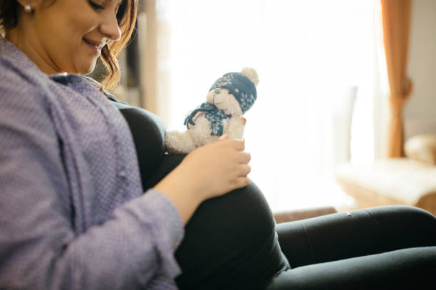 istock Pregnant woman holding toy 942096454