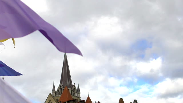 Flags waving on Notre Dame Cathedral background in Lausanne