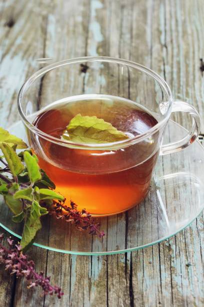 istock Tulsi Tea served in a cup with fresh leaves on the side, selective focus 942116520