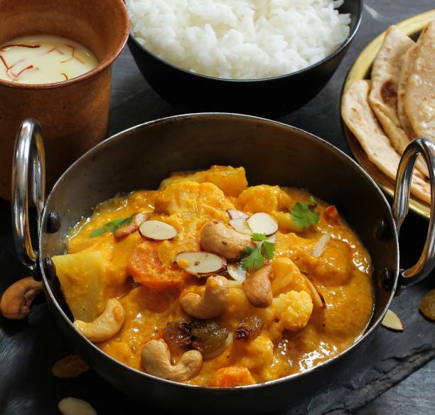 istock Vegetable or Navratan Korma - Indian Mixed Veg Curry served with Roti and rice 942116610