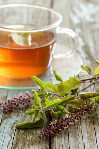 istock Tulsi Tea served in a cup with fresh leaves on the side, selective focus 942117186