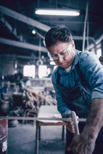 istock Middle Aged Men Use Sander Machin in his Carpentry Work Shop 942117362