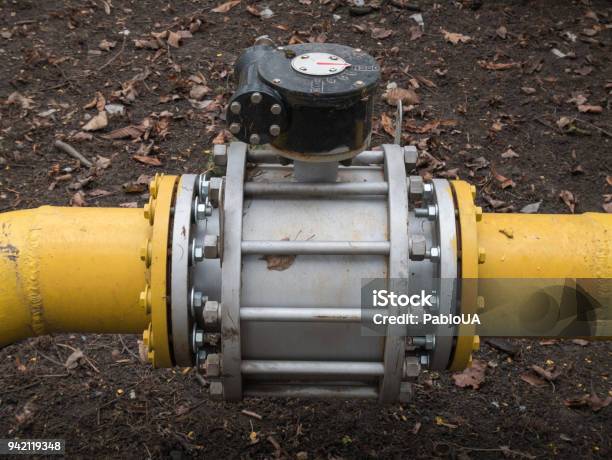 Close Up Shot Big Valve On A Thick Yellow Gas Oil Water Pipeline Tube Stock Photo - Download Image Now