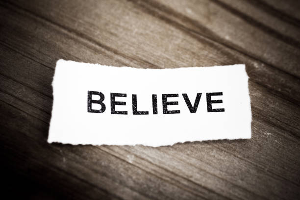 istock 'Believe' text on wood background 942123904