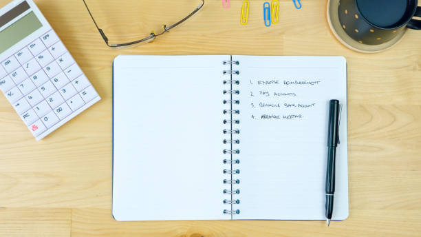 istock Empty desk with to-do list in notebook, overhead 942123970