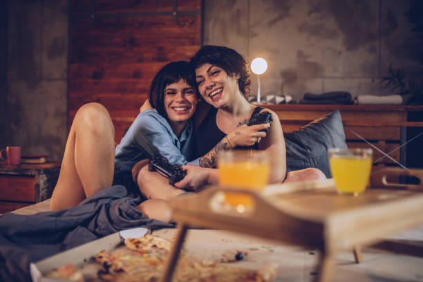 istock Couple playing video games in bed 942126164