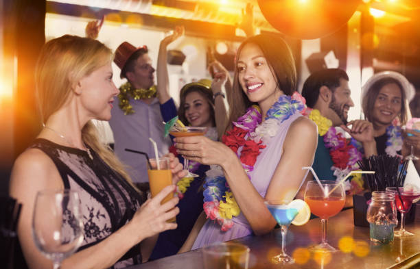 istock Two smiling female in lei are drinking cocktails 942130148