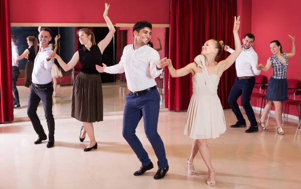 istock Young smiling people dancing samba in couple 942130266