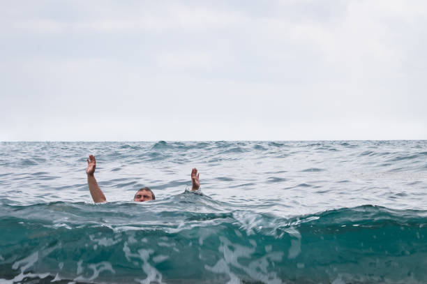 istock Man drowns and raising his hands up 942131686