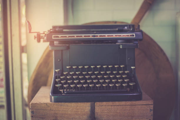 istock Vintage typewriter on a wood table , process in vintage style 942132194