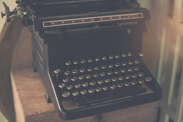 istock Vintage typewriter on a wood table , process in vintage style 942132424