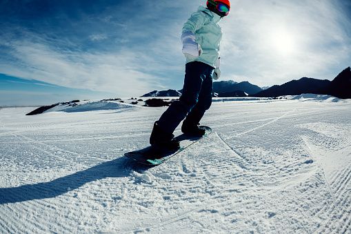 one snowboarder snowboarding in winter mountains