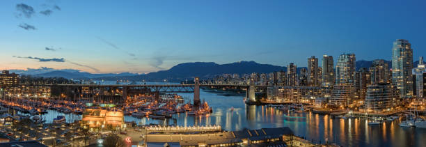 Panorama of Downtown Vancouver, British Columbia VANCOUVER, BRITISH COLUMBIA, CANADA - MARCH 30, 2018: Panorama of Downtown Vancouver, Burrard Street Bridge and Granville Island during sunset. false creek stock pictures, royalty-free photos & images