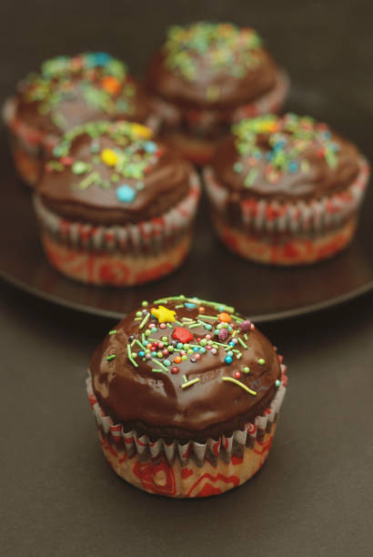 istock Homebaked Chocolate Muffins for Easter with colored Conffeti. Dark Background. Sweet Dessert for Breakfast. 942135622