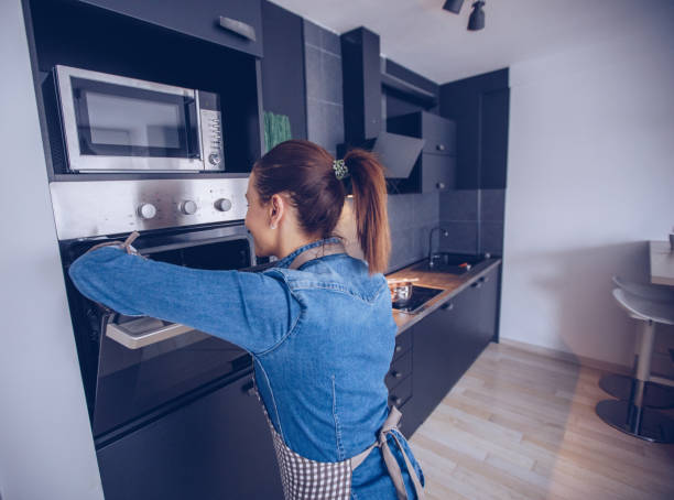 istock Woman baking dinner in oven 942135852