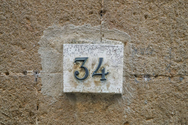 number thirty four on a wall number thirty four on a wall with copy space new york state license plate stock pictures, royalty-free photos & images
