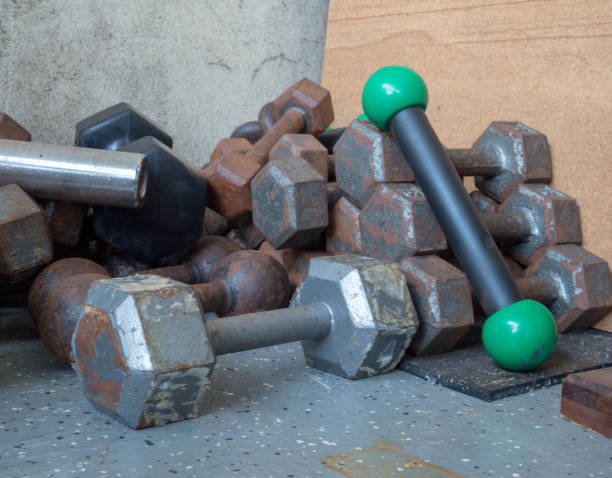 istock Messy pile of dumbbells in a gym corner 942142678