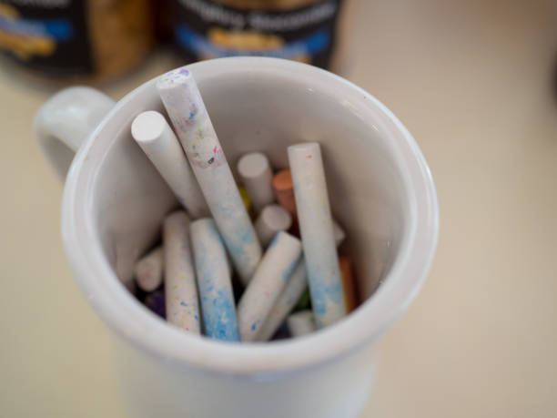 istock Pile of white chalk in a cup ready to use on blackboard 942143010