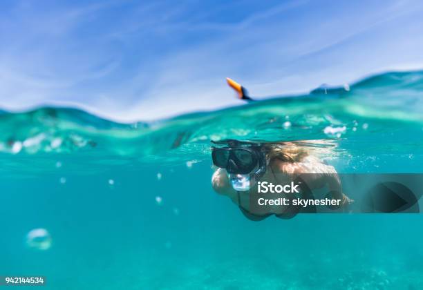 Woman Exploring The Sea While Snorkeling In Summer Day Stock Photo - Download Image Now