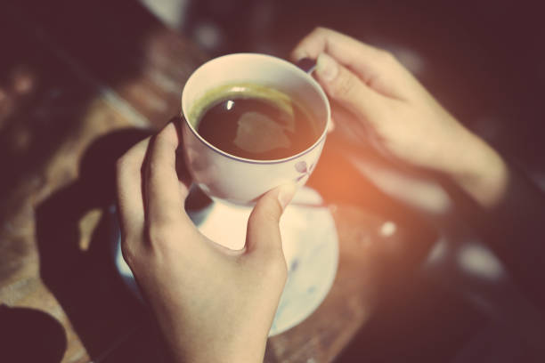 istock Female hands holding cup of coffee. 942145474