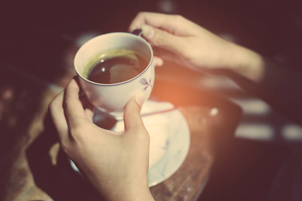 istock Female hands holding cup of coffee. 942145508