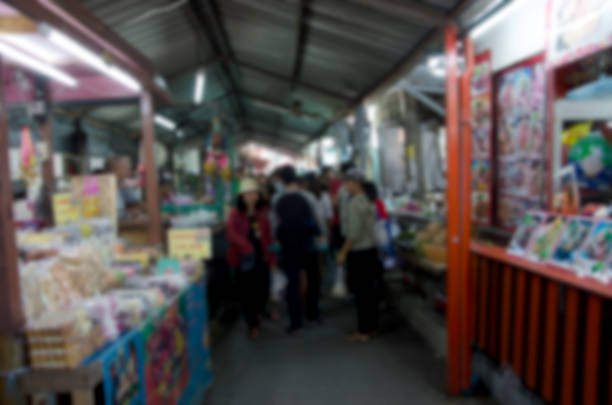 istock Abstract blurred people walking at the market. 942146816