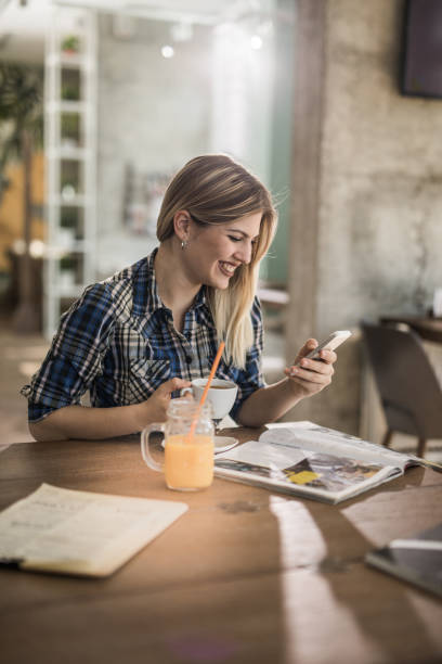 istock Young beautiful woman using smart phone in a cafe. 942147096