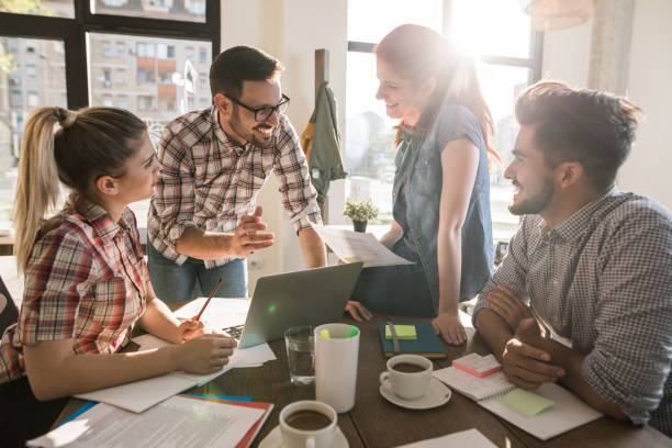 istock Happy start up team talking on a meeting at casual office. 942147430