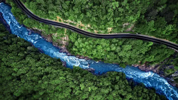 Photo of Aerial view of Mountain river and road. Mountain gorge