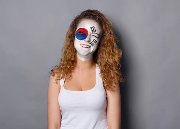 istock Young woman with Korea flag painted on her face 942150430