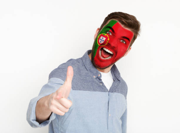 istock Young man with Portugal flag painted on his face 942150468