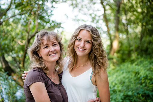 Senior smiling woman with teenager daughter. Family concept.