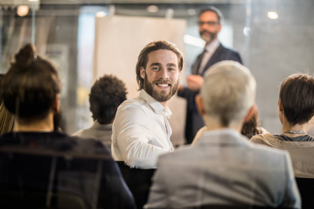 istock Happy businessman attending a training class in a board room. 942150794