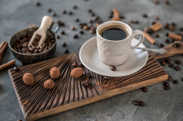 istock Black coffee with candies on a concrete background 942151030