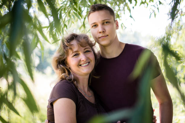 Cheerful mother and son smiling at the camera stock photo