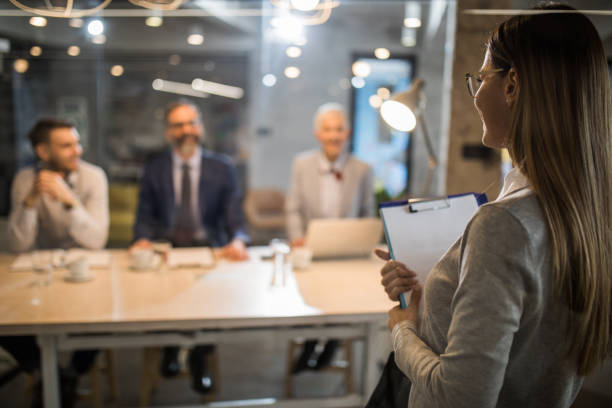 istock Young woman holding an application form while came to a job interview. 942151130