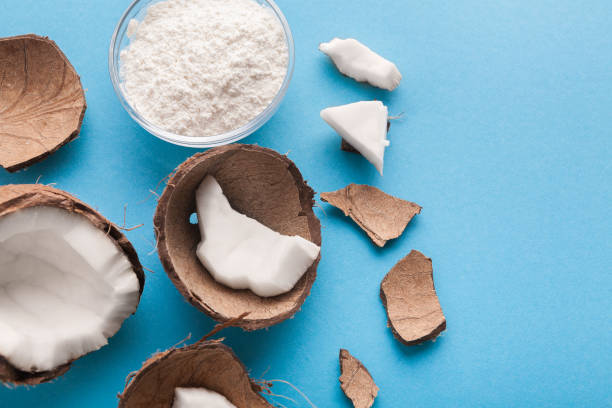 istock Plate with coconut flour and nuts on blue background 942151216