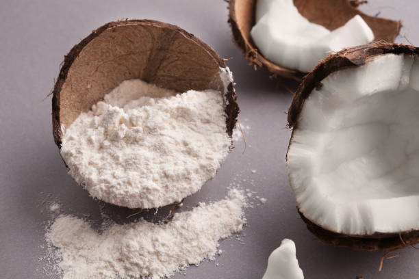 istock Coconut flour and nuts on grey background 942151386