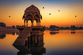 Gadisar lake at Jaisalmer Rajasthan at sunrise with ancient temples and archaeological ruins.
