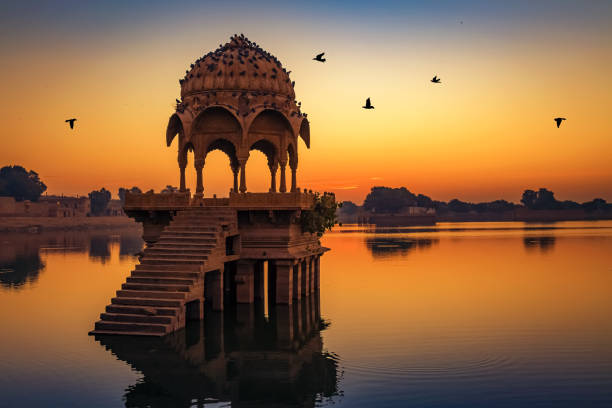 Gadisar lake at Jaisalmer Rajasthan at sunrise with ancient temples and archaeological ruins. stock photo