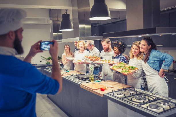 Chef is photographing attendees of cooking class