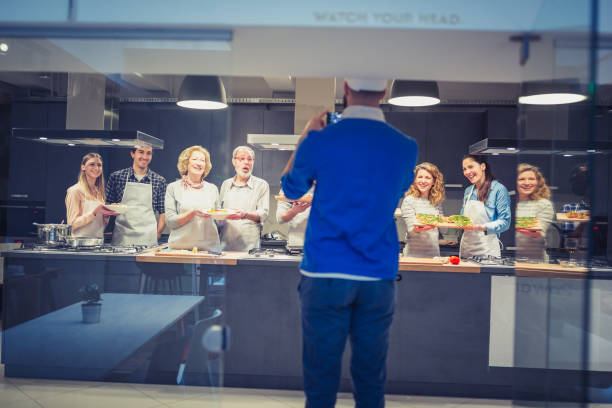 istock Chef is photographing attendees of cooking class 942153834
