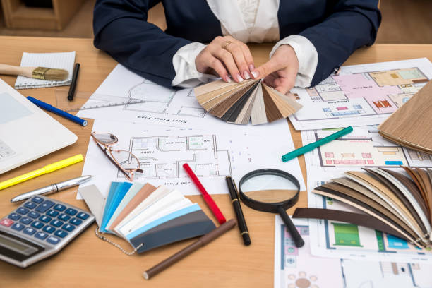 istock nterior designer with color swatch and building plans on office 942153944