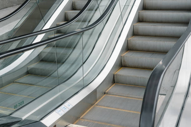 istock escalator,Up and down escalators in public building. 942154398