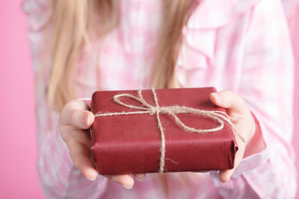 istock Gift for lover from female, holding giftbox in hands 942154536