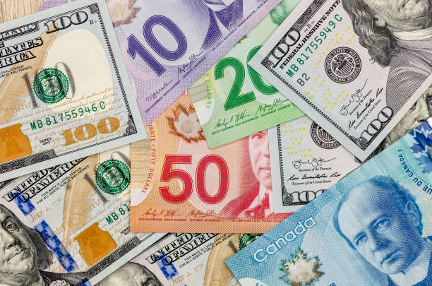 istock canadian and american dollar as background 942154610